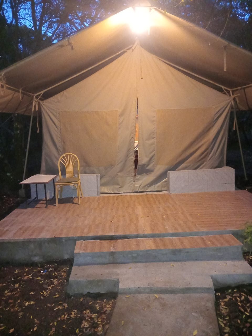 Ewuaso Riverfront tent exterior at dusk